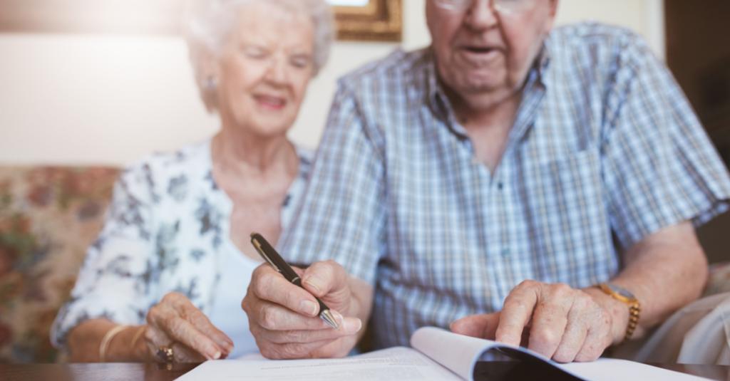 Elderly couple signing will on Australian law firm website